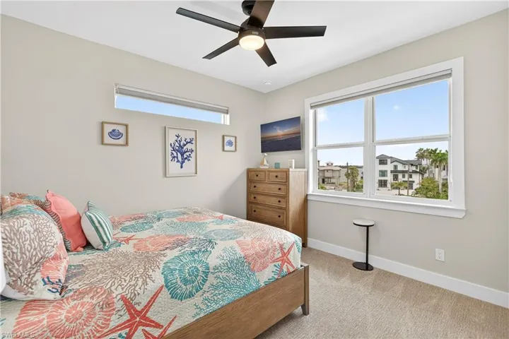 Bedroom with light colored carpet and ceiling fan - Virtually Edited Image