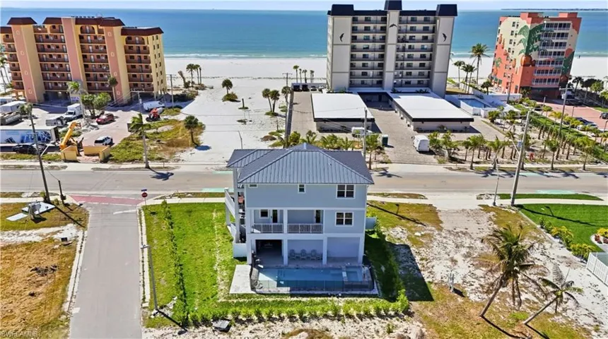 Aerial view of expansive coastline and apartment complex - Virtually Edited Image