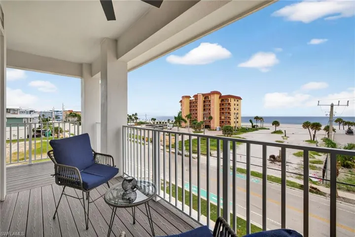 Balcony featuring a water view and a ceiling fan - Virtually Edited Image