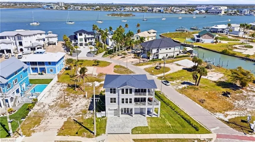 Aerial perspective of suburban area with a nearby body of water - Virtually Edited Image