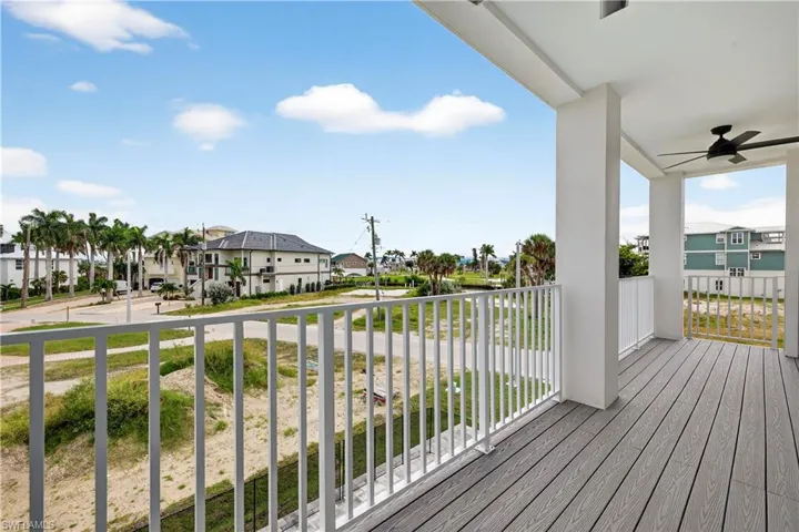 Deck featuring a residential view and a ceiling fan - Virtually Edited Image