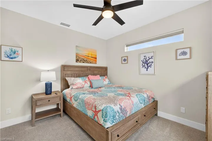 Bedroom featuring a ceiling fan and carpet flooring - Virtually Edited Image