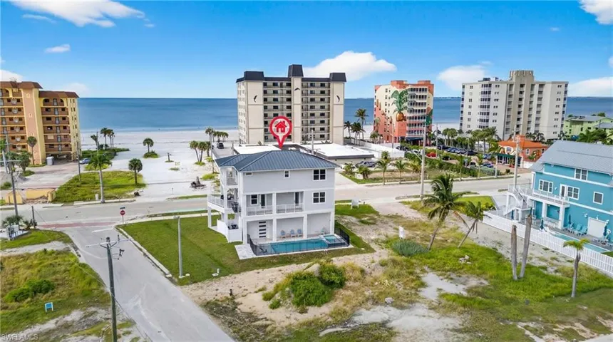 Drone / aerial view of a nearby body of water and apartment complex / building - Virtually Edited Image