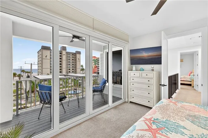 Bedroom with light carpet, access to exterior, and ceiling fan - Virtually Edited Image