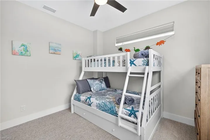 Bedroom featuring light colored carpet and ceiling fan - Virtually Edited Image