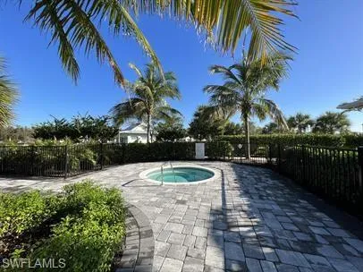 View of pool with an in-ground hot tub and a patio