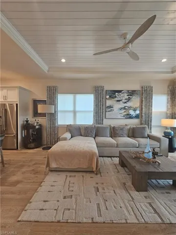 Living area with ornamental molding, light wood-type flooring, wood ceiling, and recessed lighting