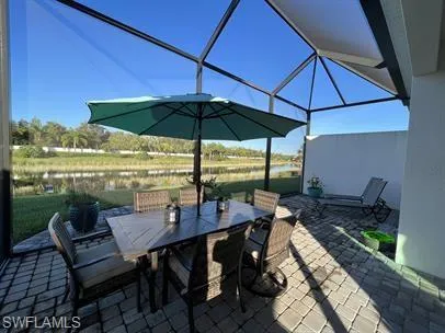View of patio / terrace with a lanai and a water view