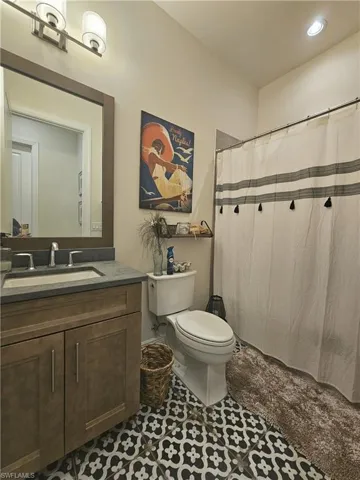 Bathroom with vanity, tile patterned floors, a shower with shower curtain, and recessed lighting