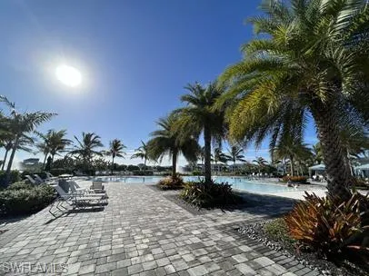 Surrounding community with a pool and a patio