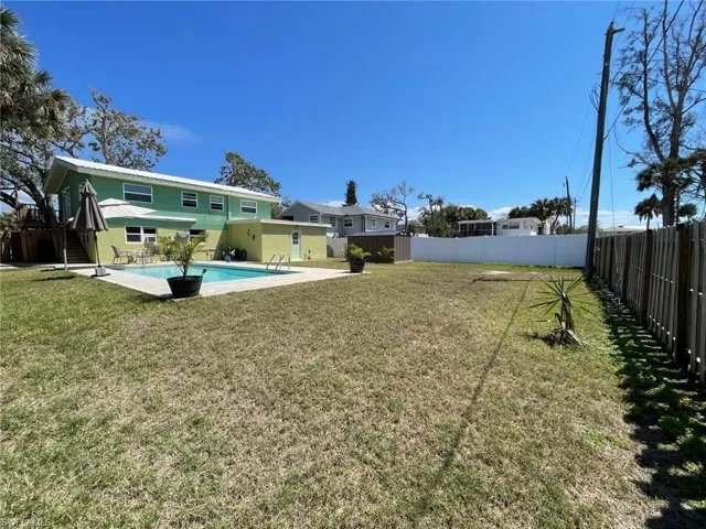 View of yard with a fenced in pool, a fenced backyard, and a patio area