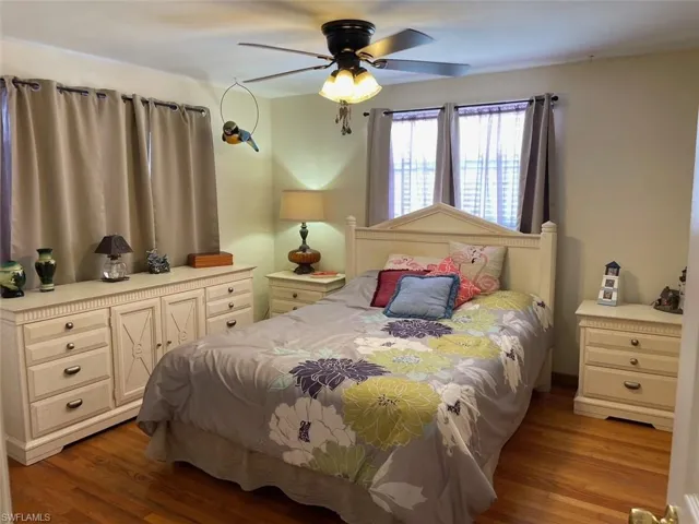 Bedroom featuring a ceiling fan and oak wood finished floors