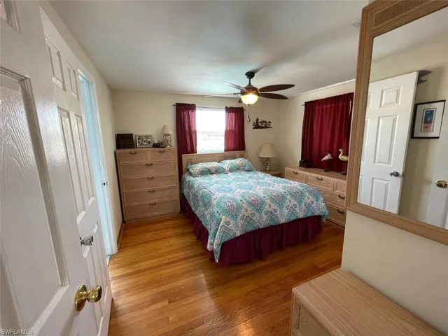 Bedroom featuring a ceiling fan and oak wood finished floors
