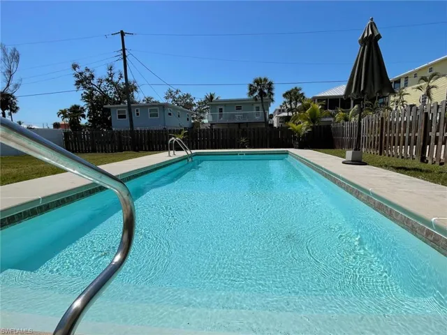 View of pool featuring a 12x28 salt water auto fill pool, and a fenced backyard
