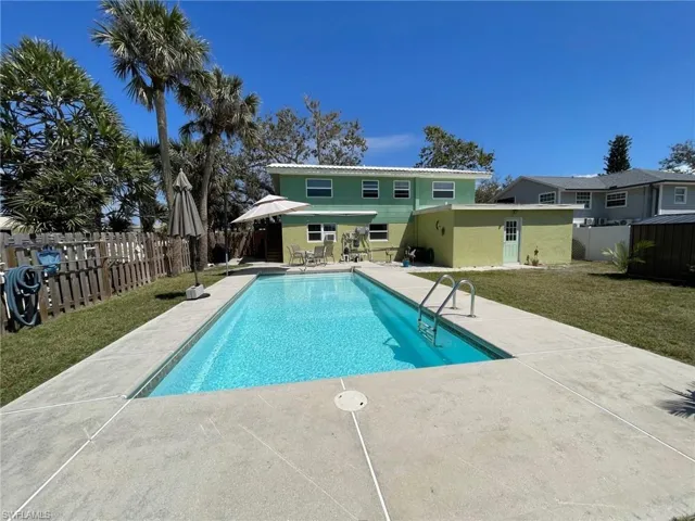 View of pool featuring a fenced in pool, a lawn, a fenced backyard, and a patio area