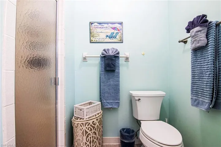 Full bathroom with toilet and a shower stall