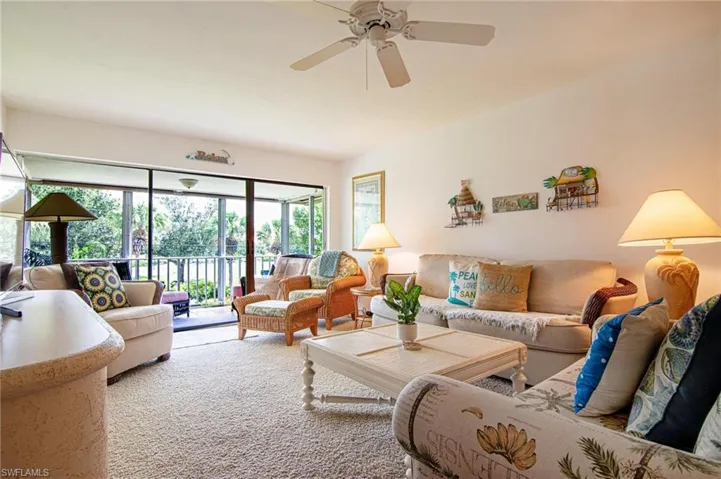 Living room with ceiling fan and carpet flooring
