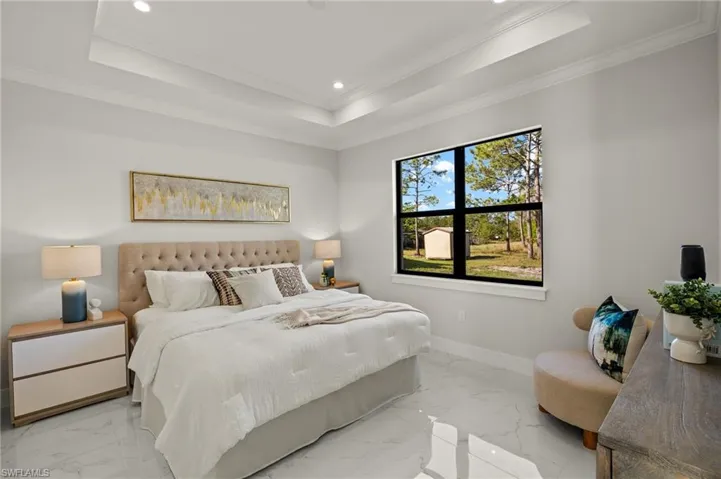 Bedroom featuring a tray ceiling, recessed lighting, ornamental molding, baseboards, and marble finish floor