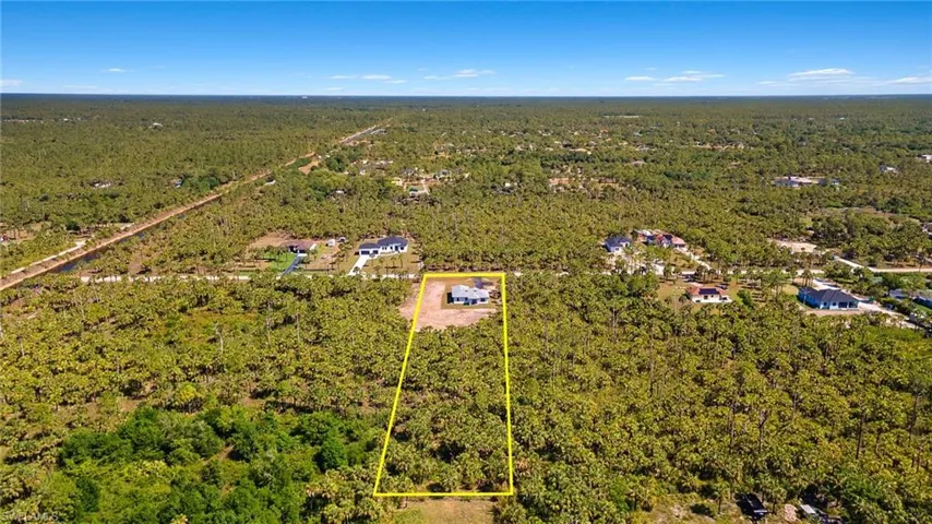 Aerial view featuring a wooded view