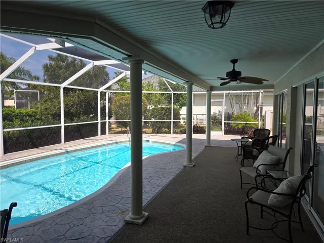 Swimming pool with a patio area, a ceiling fan, and a lanai