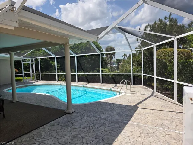 Swimming pool featuring a patio and a lanai