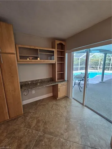 Computer desk off kitchen access to pool area