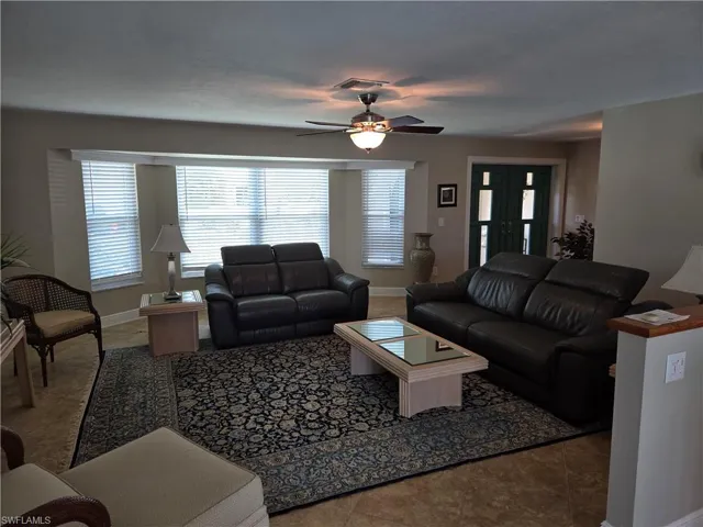 Living area with ceiling fan and healthy amount of natural light