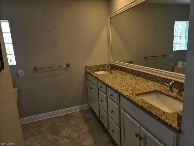 Bathroom with toilet and double vanity