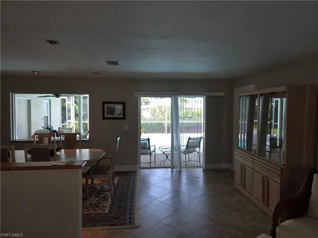 Dining area featuring tile patterned flooring and a ceiling fan