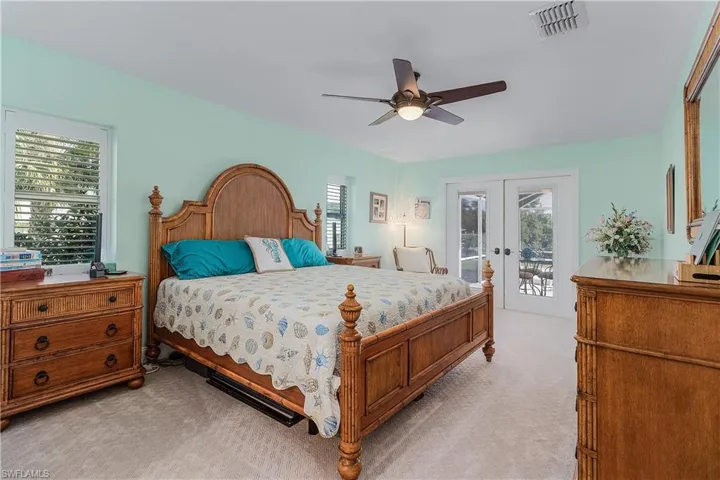 Primary bedroom that looks out to the pool area
