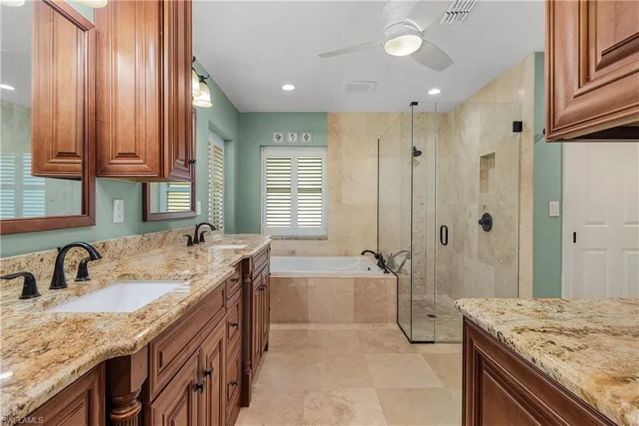 Primary Bathrrom with granite counters, double sinks and many beautiful cabinets