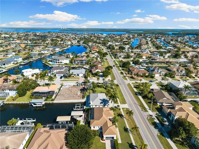 Aerial overview of property's location featuring nearby suburban area and a nearby body of water
