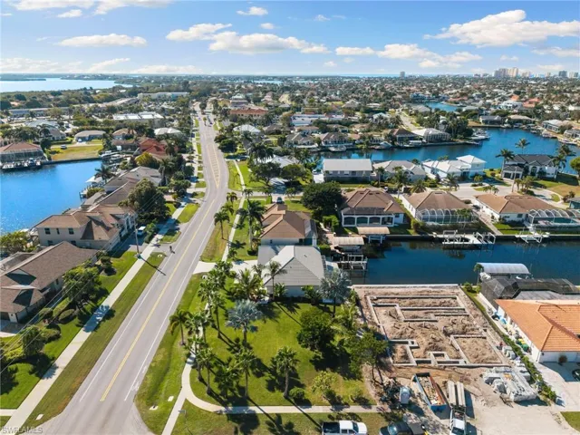 Aerial perspective of suburban area with a nearby body of water