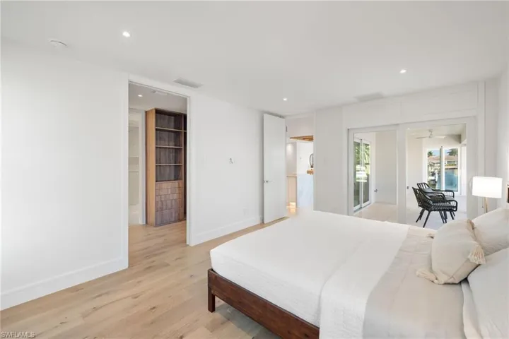 Bedroom with access to exterior, light wood-style flooring, and recessed lighting