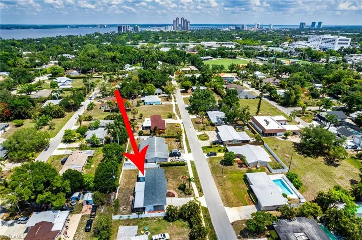 Aerial overview of property's location with nearby urban area and a nearby body of water