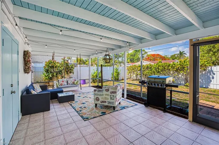Sunroom with an outdoor living space and beamed ceiling