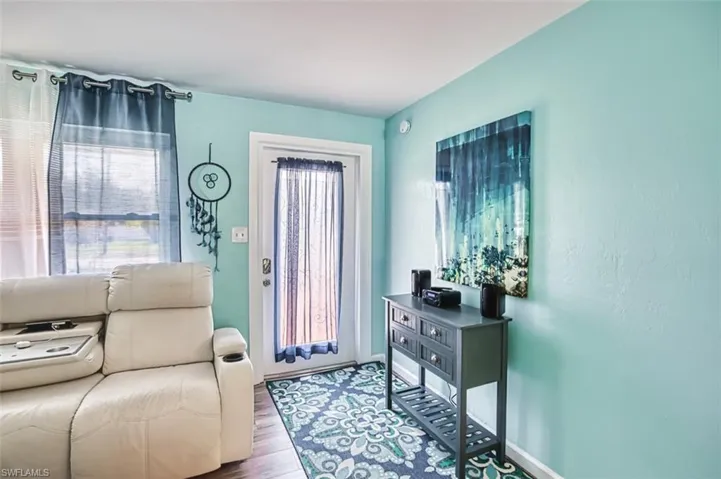 Entryway with wood finished floors and baseboards