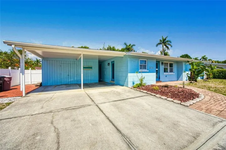 Ranch-style house with concrete driveway and concrete block siding
