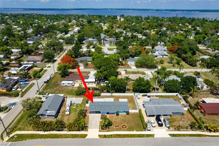 Aerial perspective of suburban area with a nearby body of water