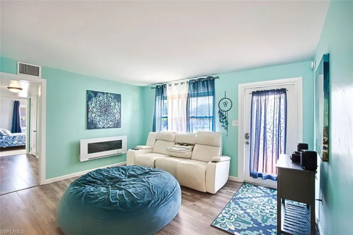 Living room featuring wood finished floors and baseboards