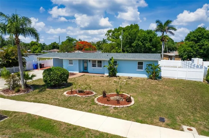 Single story home with concrete driveway, stucco siding, and a carport