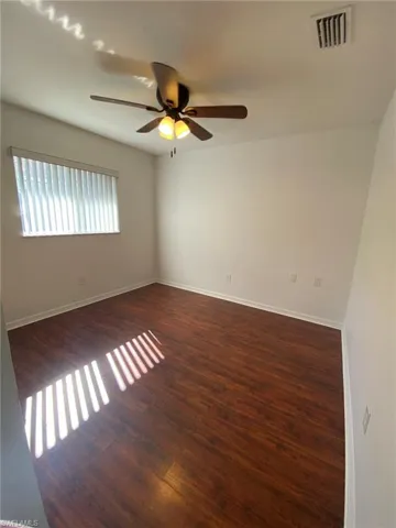 Front guest bedroom has ceiling fan and pergo floor