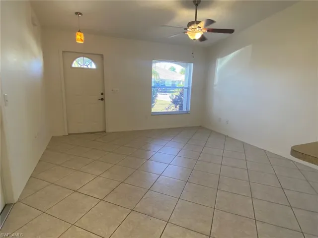 Tiled Living Room with vaulted ceiling and ceiling fan