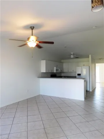 Kitchen overlooks Living Room and features a large counter bar