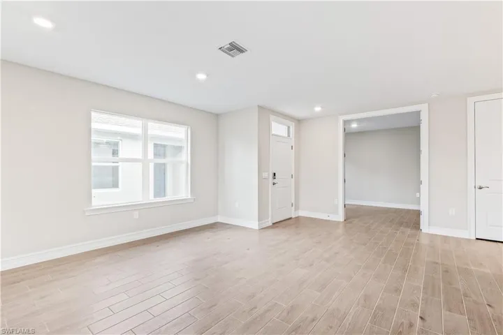 Unfurnished living room with light wood-style flooring and recessed lighting