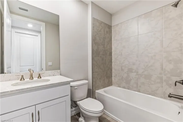 Bathroom with vanity and bathing tub / shower combination