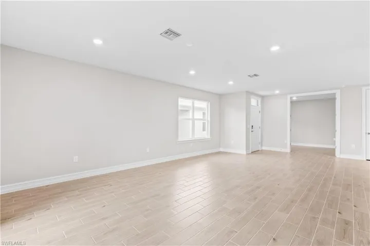 Spare room with light wood-type flooring and recessed lighting