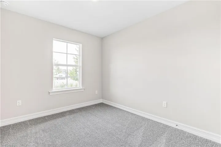 Empty room with baseboards and carpet floors