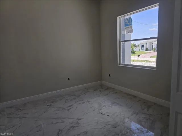 Empty room featuring tile flooring