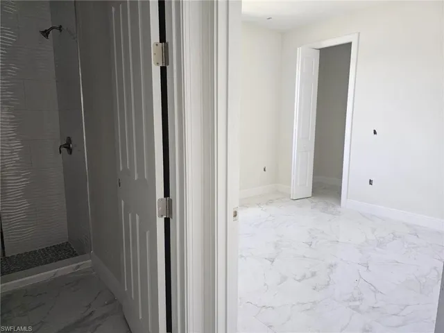 Bathroom with tile flooring and tiled shower